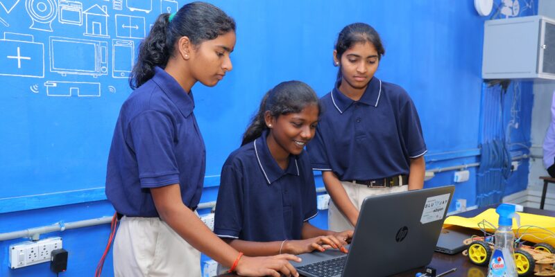 Three female students at the Coding Academy in Telangana.
